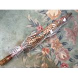 A ladies parasol, late Edwardian with a wooden handle, with also a etched pattern,