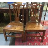 A pair of George III joined oak side chairs with pierced central splats,