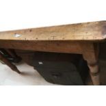 A Victorian pine kitchen table with turned legs, 75cm high, 136cm wide,
