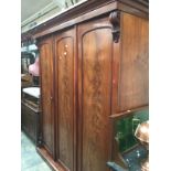 A late Victorian three door wardrobe in mahogany.