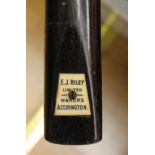 An EJ Riley snooker cue with tin case