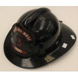 US Fire Department late 1960's Black plastic helmet with leather "East End Hose Derby 3" badge to
