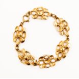 A 9ct gold bracelet, six pebble design open and solid links, length approx 7'',