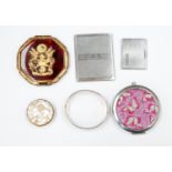 A silver bangle, Birmingham 1973, a German powder compact mirror, pill box,