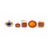 Five carnelian set 19th Century fobs to include two carved intaglio