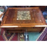 A large mahogany coffee table, with marble inset and lift up compartments,