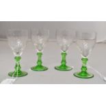 Four Edwardian green stemmed sherry glasses