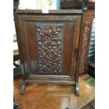 An ornate carved oak fire screen, width approx 46cm,