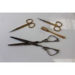 Two pairs of Asprey gilded dressing table scissors with engine turned decoration,
