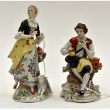 A pair - Sitzendorf figurines of a lady with a lamb and a seated man with birds and cage 6¼ and 5