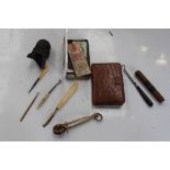 A ladies skirt lifter button hooks, needlework case and tin of needles, rolled gold button hook,