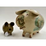 An Art Pottery Gordon Studio piggy bank, on a terracotta base, cork stopper,