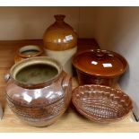 A collection of assorted stoneware and terracotta jars, stoneware flagons, some of local interest,