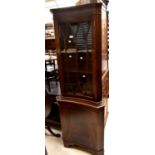 A 1980's reproduction mahogany corner cupboard,