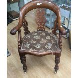 A Victorian parlour arm chair, walnut frame, porcelain castors, carved fretwork, upholstered back,