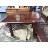 A mahogany dining table with two extending leaves