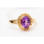 An amethyst and 14ct gold dress ring, set with an oval amethyst with fancy mount, size P,