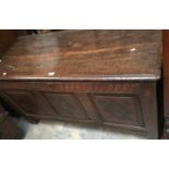 A late 17th / early 18th Century joined oak chest, fitted with a plank lid, three panels to front,