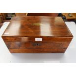 A 19th Century rosewood rectangular writing box, the interior opening to reveal slopefront section,
