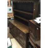 A Georgian style joined oak dresser and rack, the upper section with plate shelves,