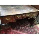 An early 18th century oak lowboy on splayed legs..