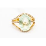 A 14k dress ring, set with an oval faceted blue/green quartz with diamond set shoulders,