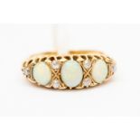 A Victorian opal and diamond 18ct gold ring, set with three oval opals, with diamond accents,