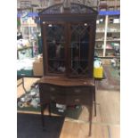 A George V mahogany glazed bookcase, the upper section with pierced arched pediment,