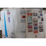 A collection of mixed stamps and albums, postcards, various FDCs, cigarette cards etc.
