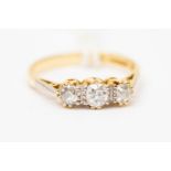 An 18ct gold ring set with three diamonds, total diamond weight approx 0.