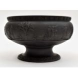 A 19th Century Wedgwood black basalt pedestal bowl, depicting classical figures in relief,