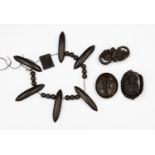 A collection of Whitby jet comprising of a Victorian locket, a floral brooch,