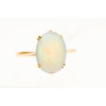 An opal gold ring in original box, claw set in 9ct gold, the oval opal approx 13mm x 9mm, size R,