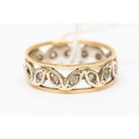 A 9ct yellow and white gold dress ring, set with white stones inset into leaf details,