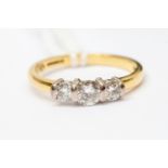 A diamond three stone 18 ct gold ring,