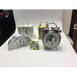 A collection of assorted clocks, comprising alarm clock, three mantle clocks,