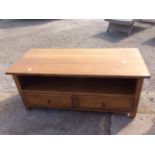 A contemporary solid oak two drawer coffee table