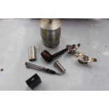 A collection of assorted smoking related items, including two silver table lighters, pipe,