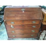 A George III mahogany bureau, the fall front enclosing a fitted interior,