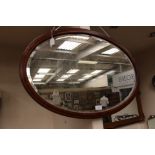 An inlaid Regency revival Edwardian oval mirror