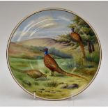 A painted plate with three pheasants, signed G.