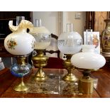 Four oil lamps, three brass based, one turquoise glass,