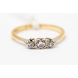 An 18ct gold and platinum three stone diamond ring, size N, total gross weight approx 2gms,