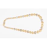 A 14k gold tri colour gold necklace, alternate coloured graduated circular shaped links,