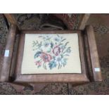 A piano stool with a woolwork panel in lid.