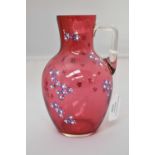 Cranberry glass jug with enamelled decoration