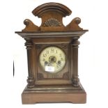 A late 19th Century American walnut cased eight day mantle clock, cream enamelled dial,