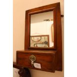 A walnut veneer late 19th Century wall mirror and candle drawer