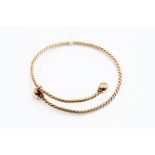 9ct gold slave bangle of sprung rope twist design, ball shaped terminals, weight approx 15.