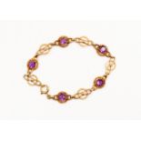 A 9ct gold and amethyst bracelet, set with five claw set amethysts, with alternate fancy links,